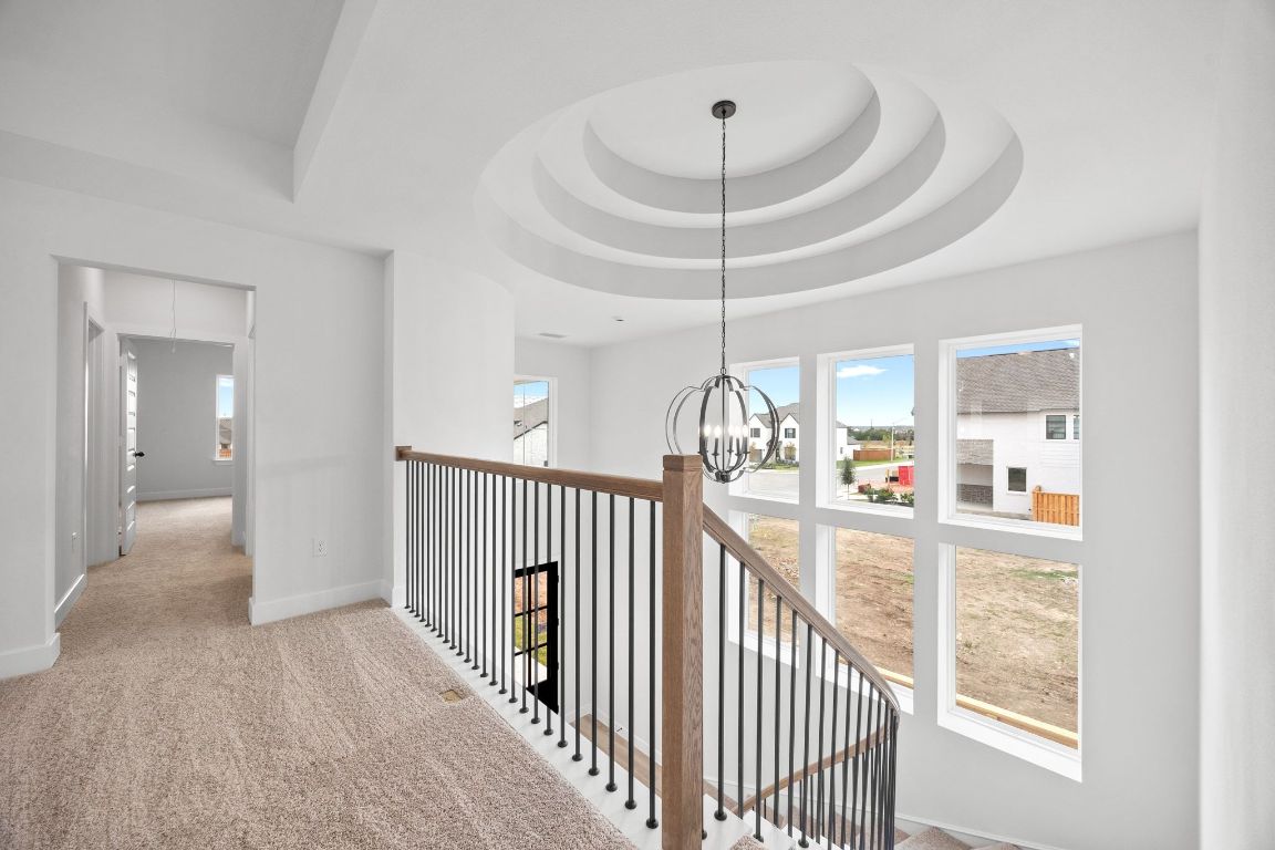 617 Buckaroo Drive Georgetown, TX 78633 - Photo 18 of 33 a view of a hallway with a chandelier and livingroom