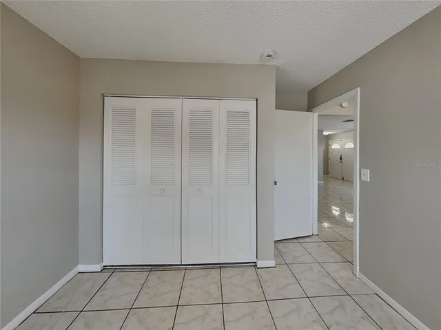 a view of an empty room and closet area