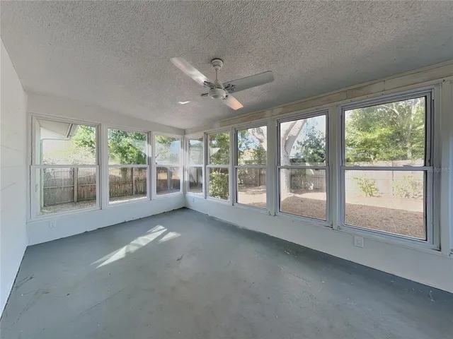 a view of room with window and a ceiling fan