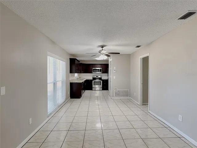a view of a kitchen with microwave and cabinets