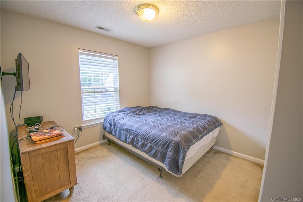 7016 Blithe Low Place Charlotte, NC 28273 - Photo 12 of 15 a spacious bedroom with a bed and a window