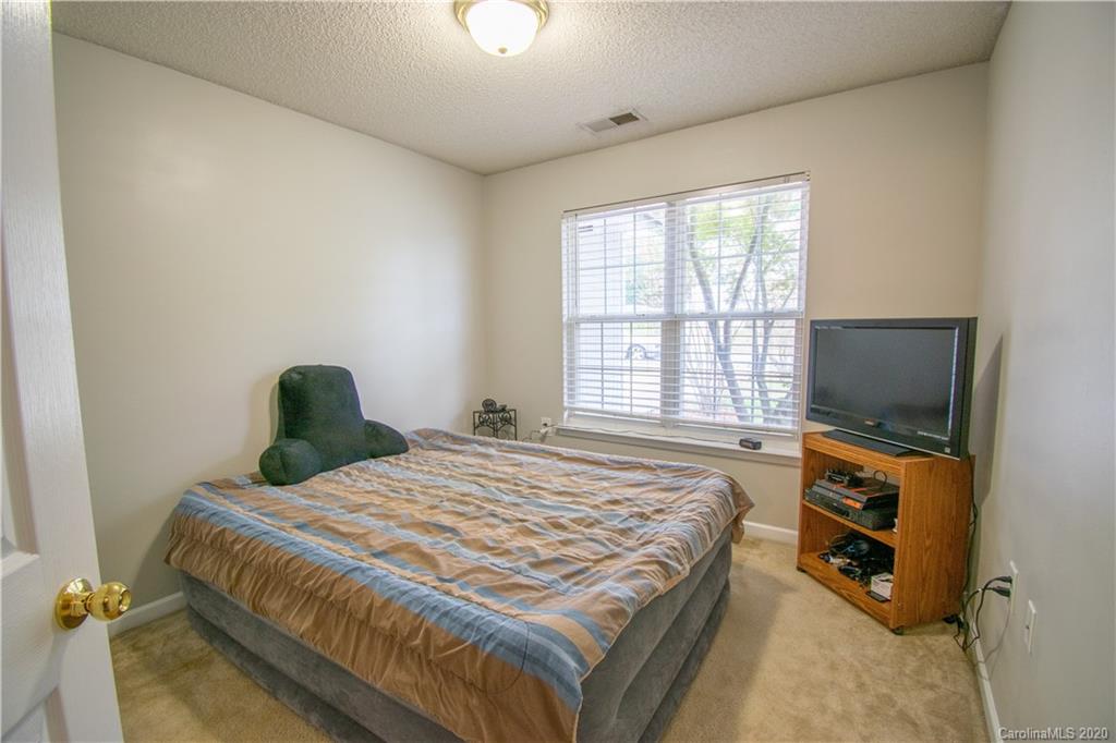 7016 Blithe Low Place Charlotte, NC 28273 - Photo 13 of 15 a bedroom with a bed and a flat screen tv