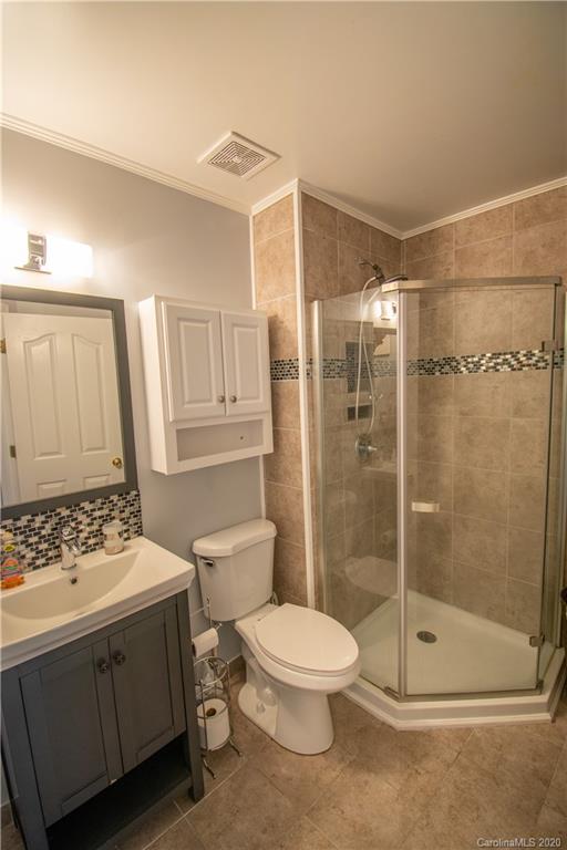 7016 Blithe Low Place Charlotte, NC 28273 - Photo 14 of 15 a bathroom with a toilet a sink and shower