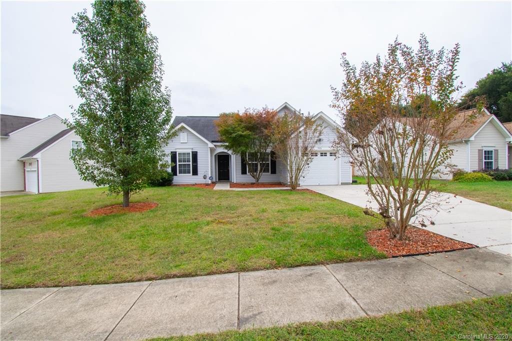 7016 Blithe Low Place Charlotte, NC 28273 - Photo 3 of 15 a front view of a house with a garden and trees