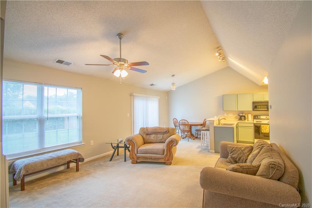 7016 Blithe Low Place Charlotte, NC 28273 - Photo 5 of 15 a living room with furniture and a ceiling fan