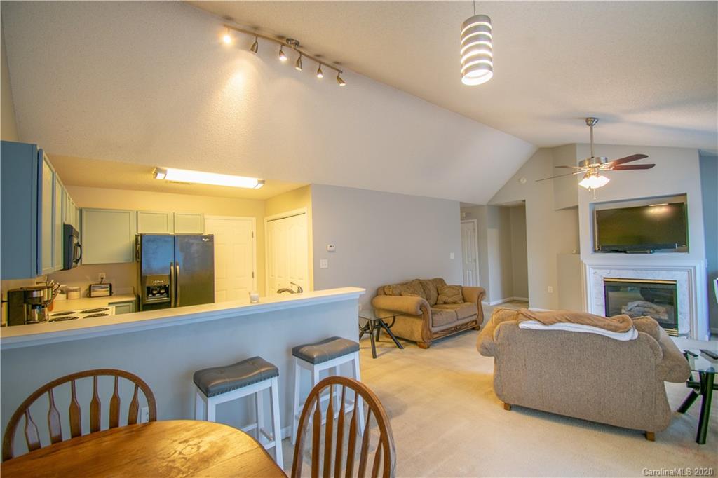 7016 Blithe Low Place Charlotte, NC 28273 - Photo 6 of 15 a bedroom with a bed a mirror and a flat screen tv