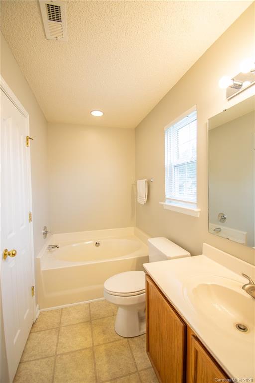 7016 Blithe Low Place Charlotte, NC 28273 - Photo 10 of 15 a bathroom with a granite countertop sink a toilet and shower