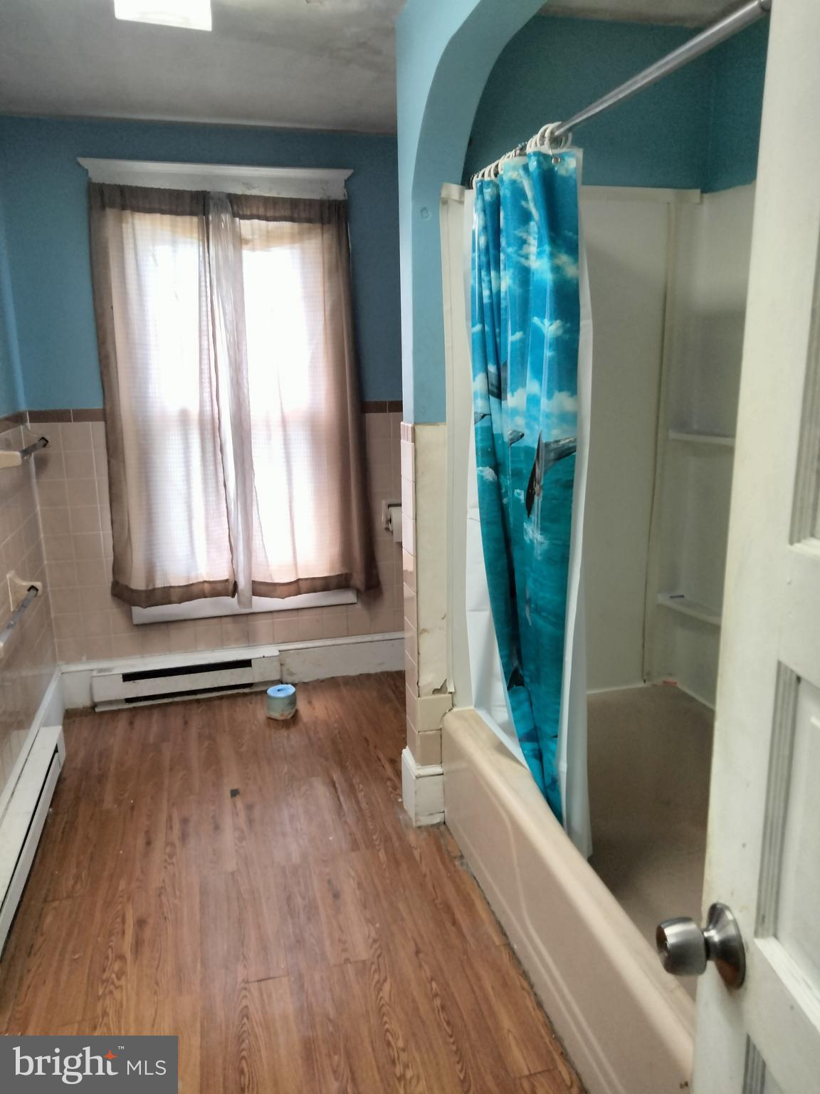 7411 Main Street Willards, MD 21874 - Photo 24 of 43 a view of front door with wooden floor and chair