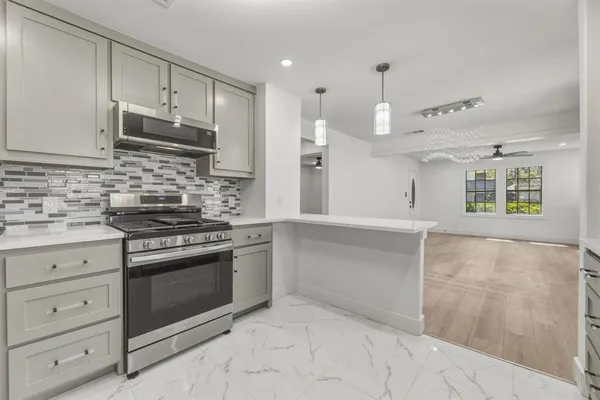 a kitchen with granite countertop a stove oven and sink