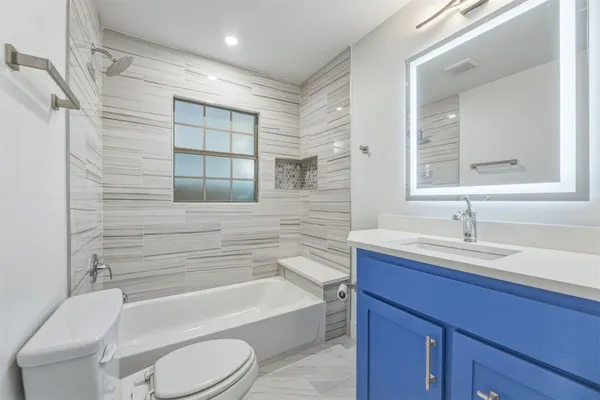 a bathroom with a sink a toilet and bathtub