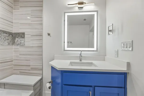 a bathroom with a sink and a mirror