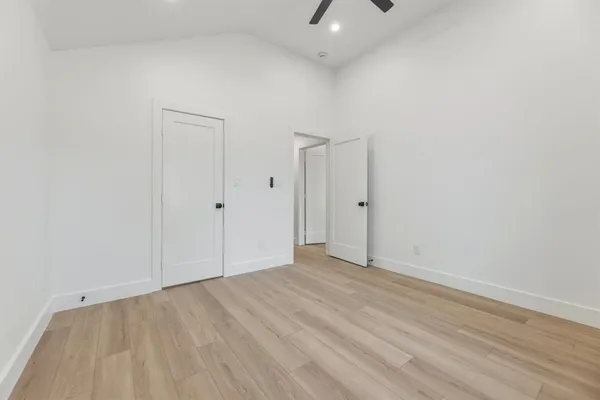 a view of an empty room with wooden floor