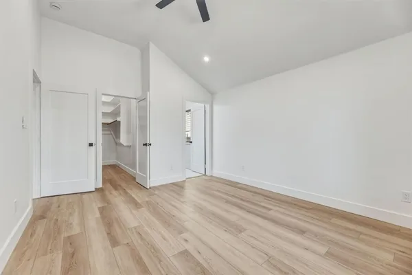 a view of an empty room with wooden floor