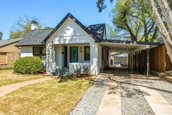 a view of house with backyard outdoor seating area and garage