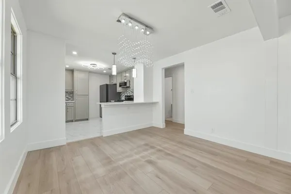 a view of a kitchen with a sink and a refrigerator