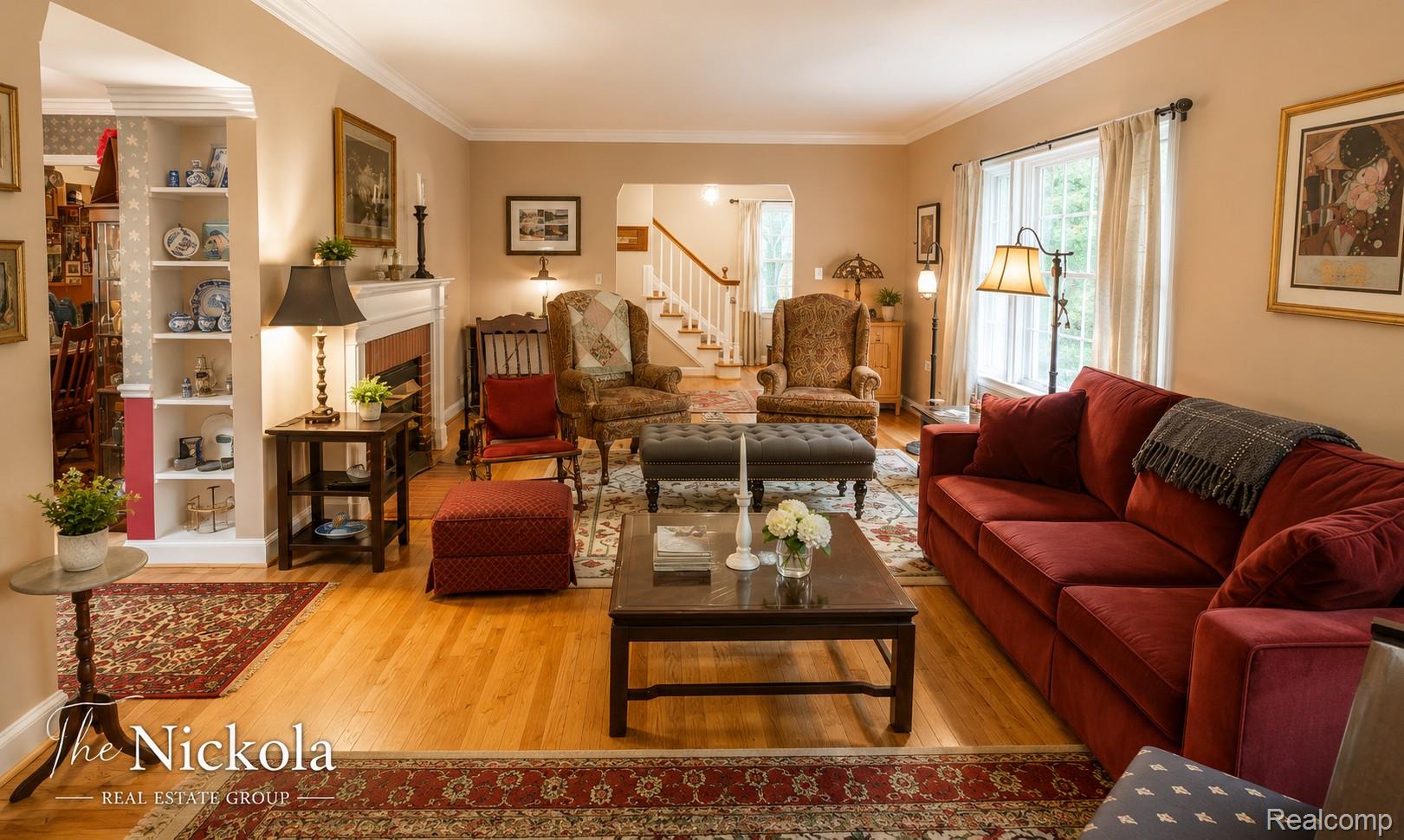 515 Barrington Road Detroit, MI 48215 - Photo 7 of 27 Living area with light wood-type flooring, a fireplace, crown molding, and arched walkways