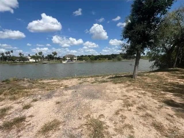 a view of a lake with houses in the back