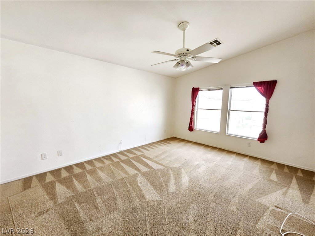 1663 Lefty Garcia Way Henderson, NV 89002 - Photo 6 of 31 A well-lit bedroom with fresh carpet and ample natural light for comfortable living.