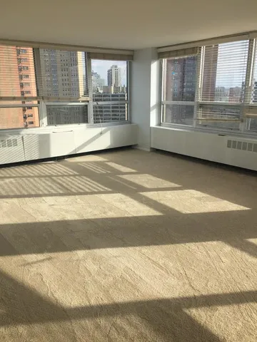 a bathroom with a tub sink and large window