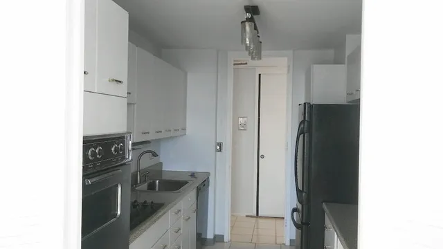 a kitchen with a refrigerator and a sink