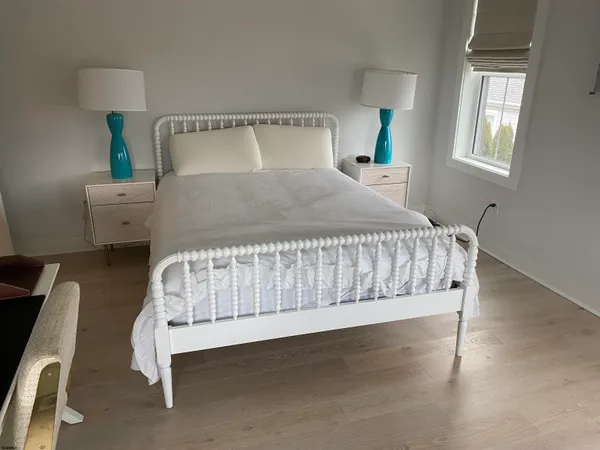 a bedroom with bed and window