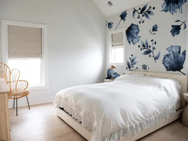 a bedroom with two beds and a window