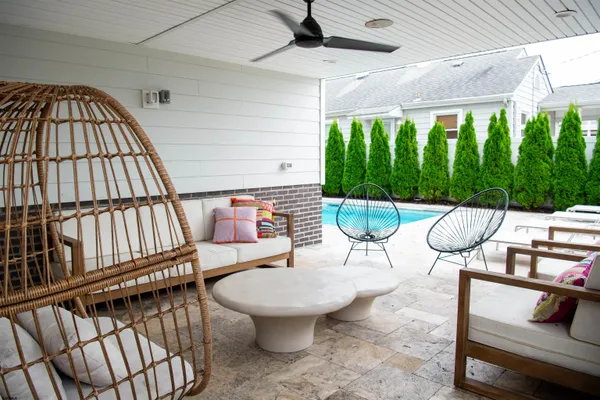 a living room with furniture a flat screen tv and a large window