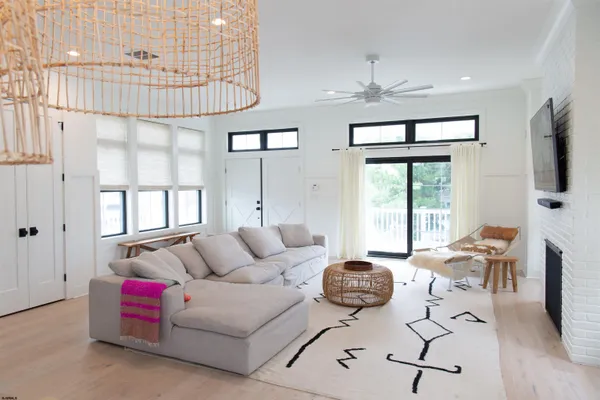 a living room with furniture and large windows