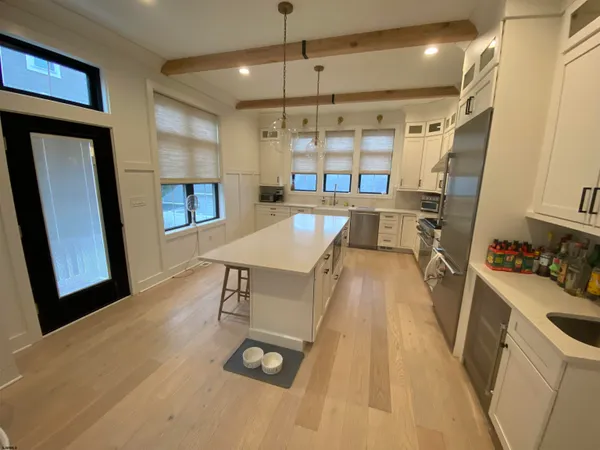 a large bed sitting in a bedroom next to a window and mirror
