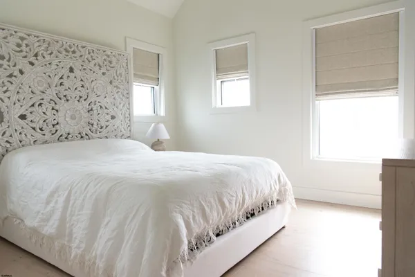 a bedroom with a bed and a lamp on table