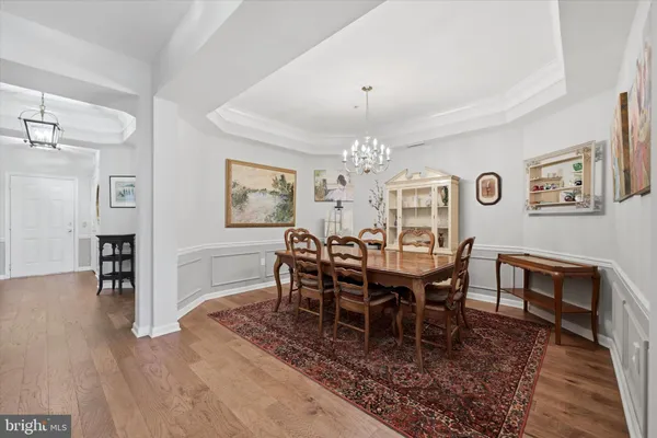 a view of a dining room with furniture wooden floor and chandelier