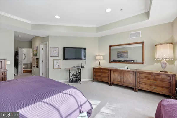 a bedroom with a bed and a flat screen television