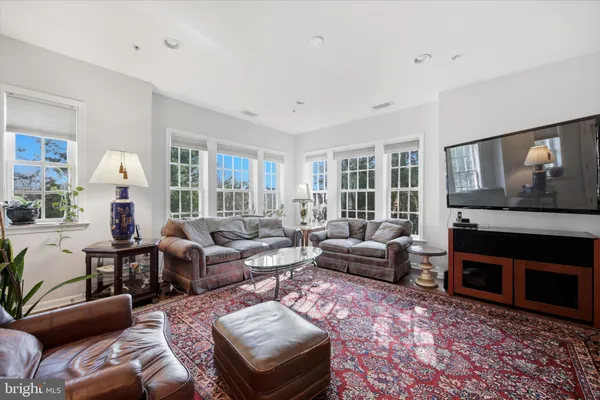 a living room with furniture fireplace and a window