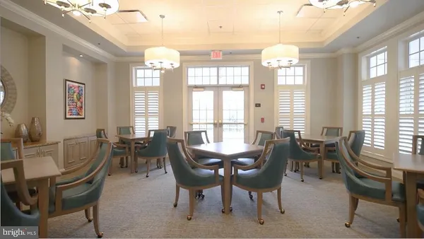 a view of a dining room with furniture and a book shelf