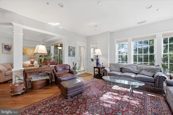a living room with furniture couches and a large window