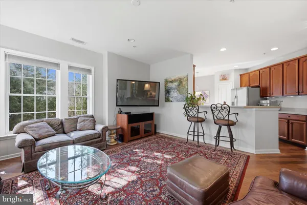 a living room with furniture a rug and a flat screen tv