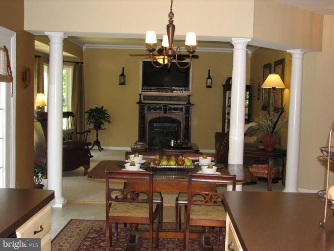 5910 Sunlight Mountain Road Spotsylvania, VA 22553 - Photo 14 of 30 a living room with fireplace furniture dining table and a fireplace