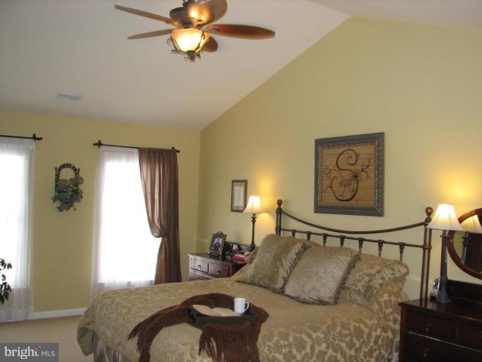 5910 Sunlight Mountain Road Spotsylvania, VA 22553 - Photo 21 of 30 a bedroom with a bed and a chandelier