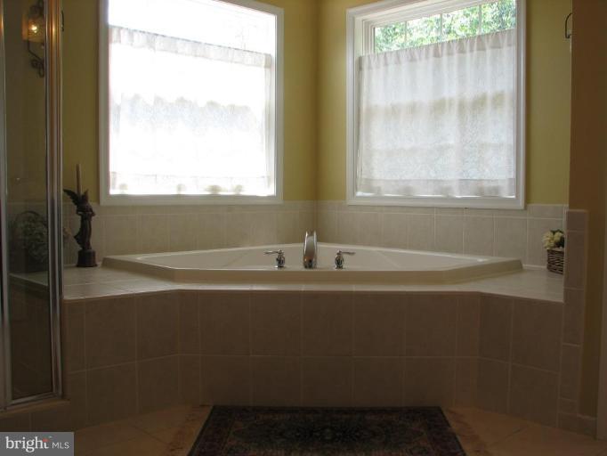 5910 Sunlight Mountain Road Spotsylvania, VA 22553 - Photo 25 of 30 a bathroom with a bathtub and a shower