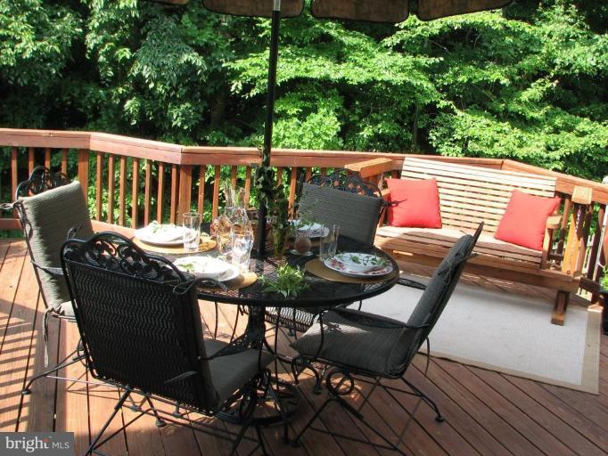 5910 Sunlight Mountain Road Spotsylvania, VA 22553 - Photo 8 of 30 a view of a chairs and table on the deck