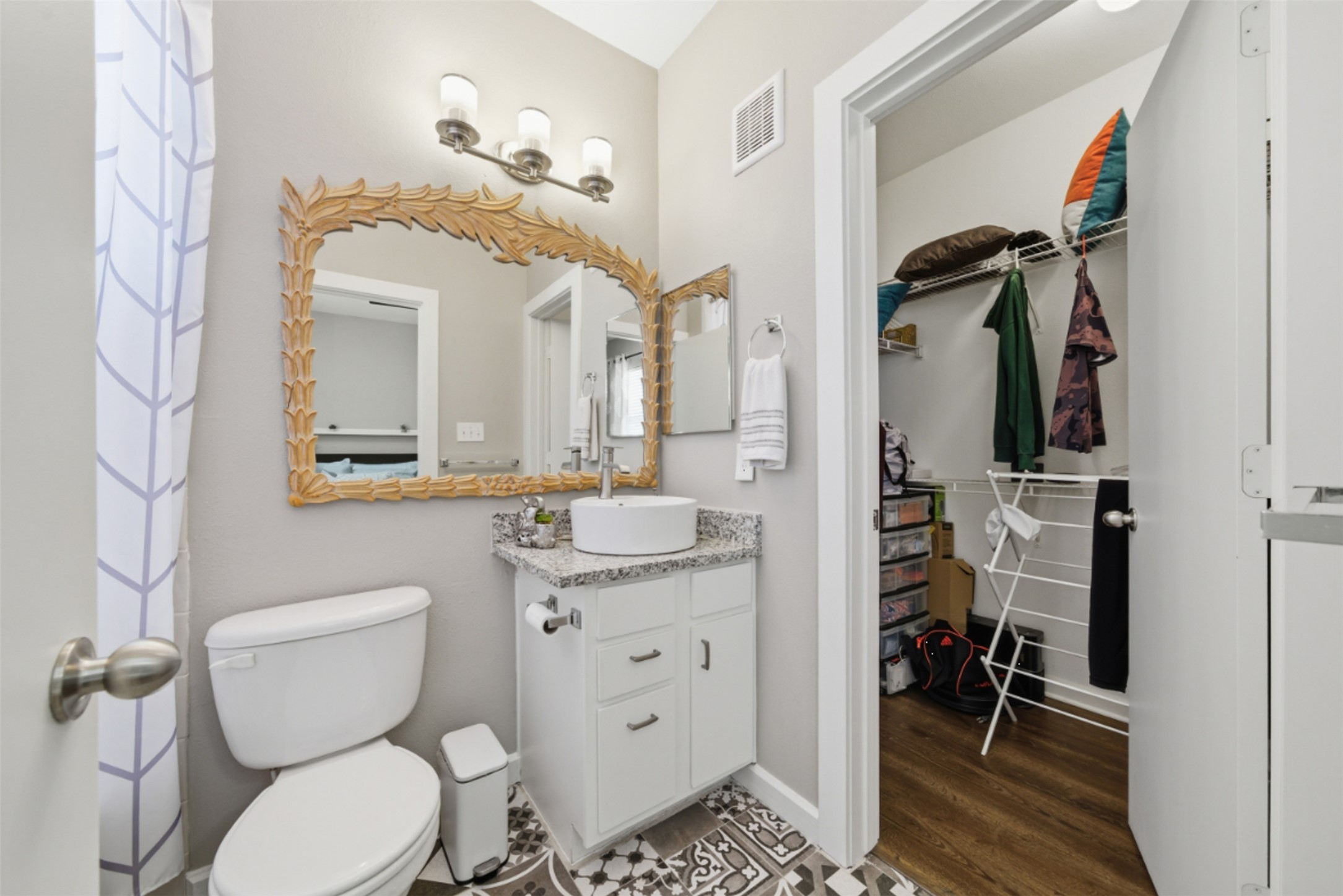 1201 Grove Boulevard, Unit 1304 Austin, TX 78741 - Photo 16 of 19 a bathroom with a toilet a sink and mirror