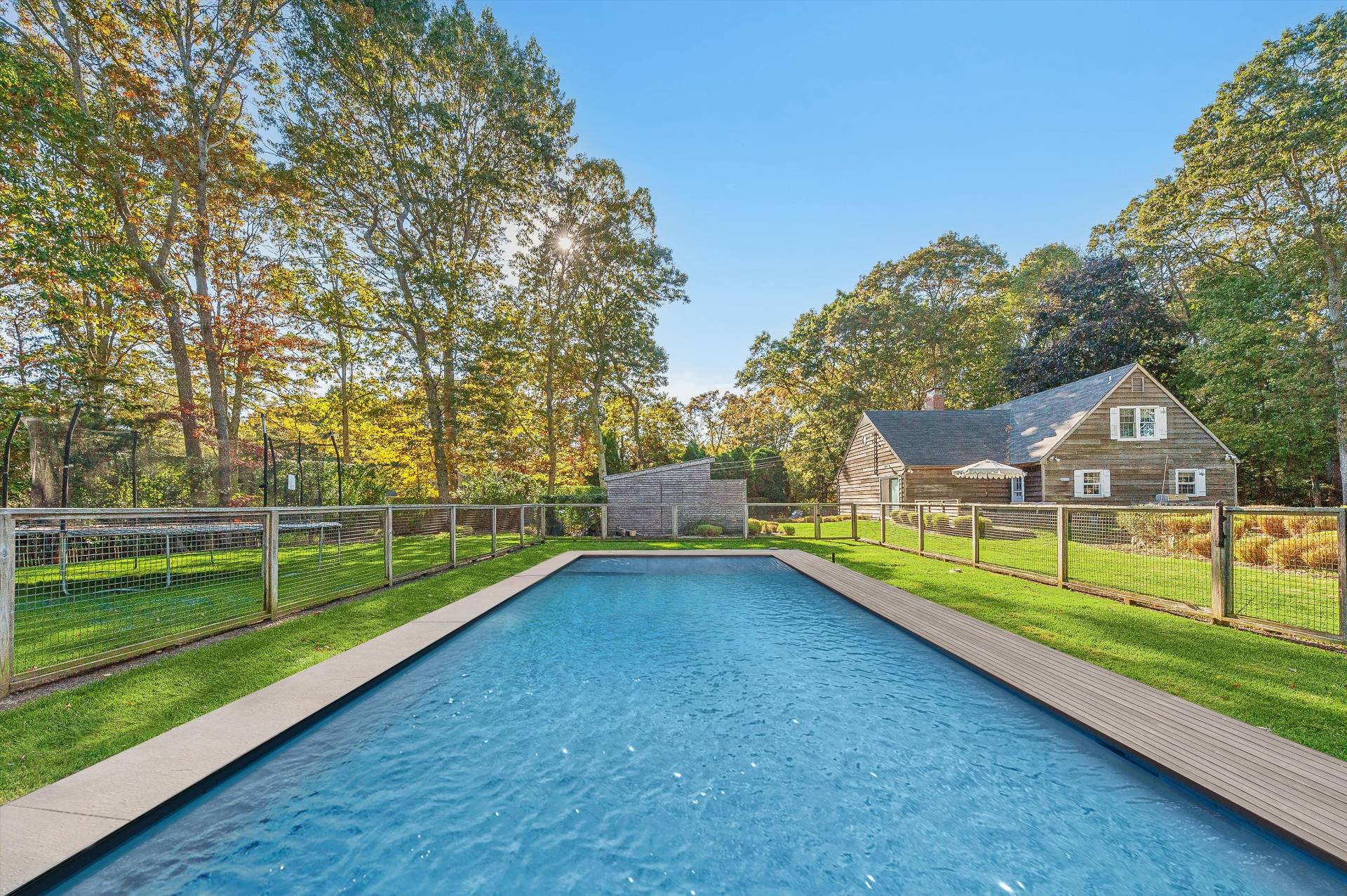 a view of an house with a backyard and a lake view