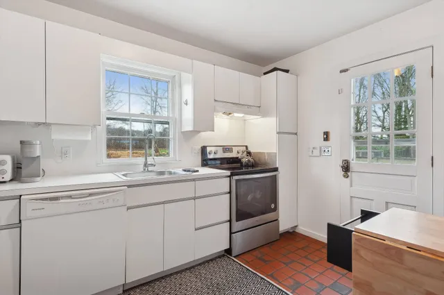 a kitchen with a sink stove and refrigerator