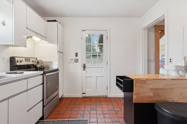 a kitchen with a sink and a stove top oven
