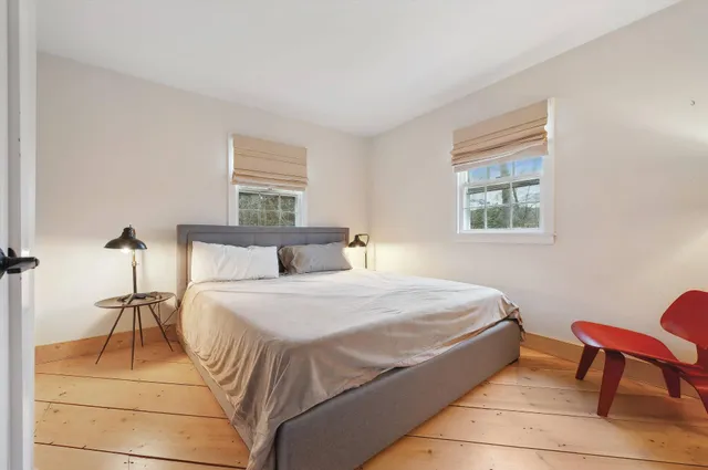 a bedroom with a bed and a chair