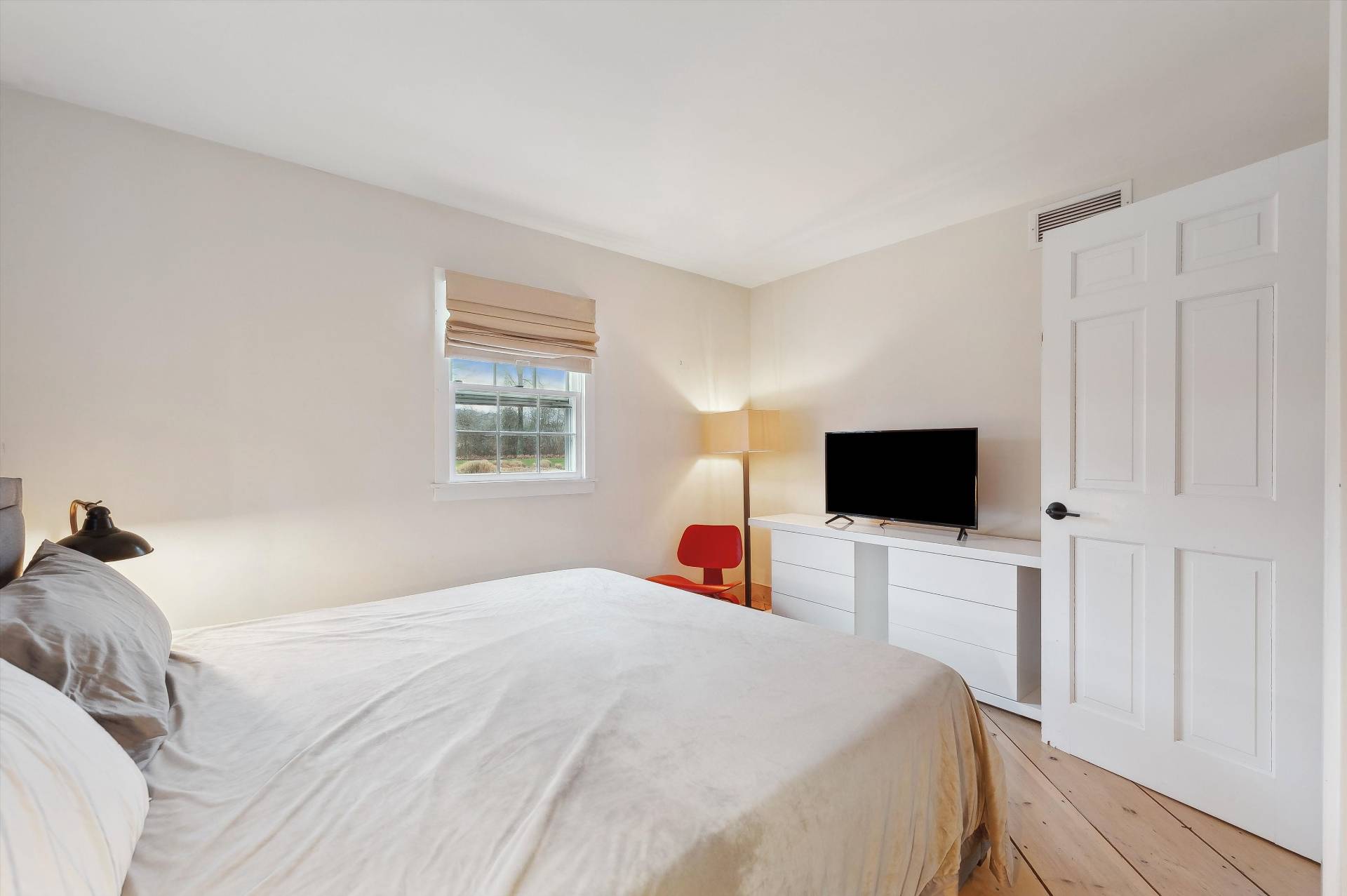 356 7 Ponds Towd Road Water Mill, NY 11976 - Photo 15 of 22 a bedroom with a bed and a flat tv screen on wall