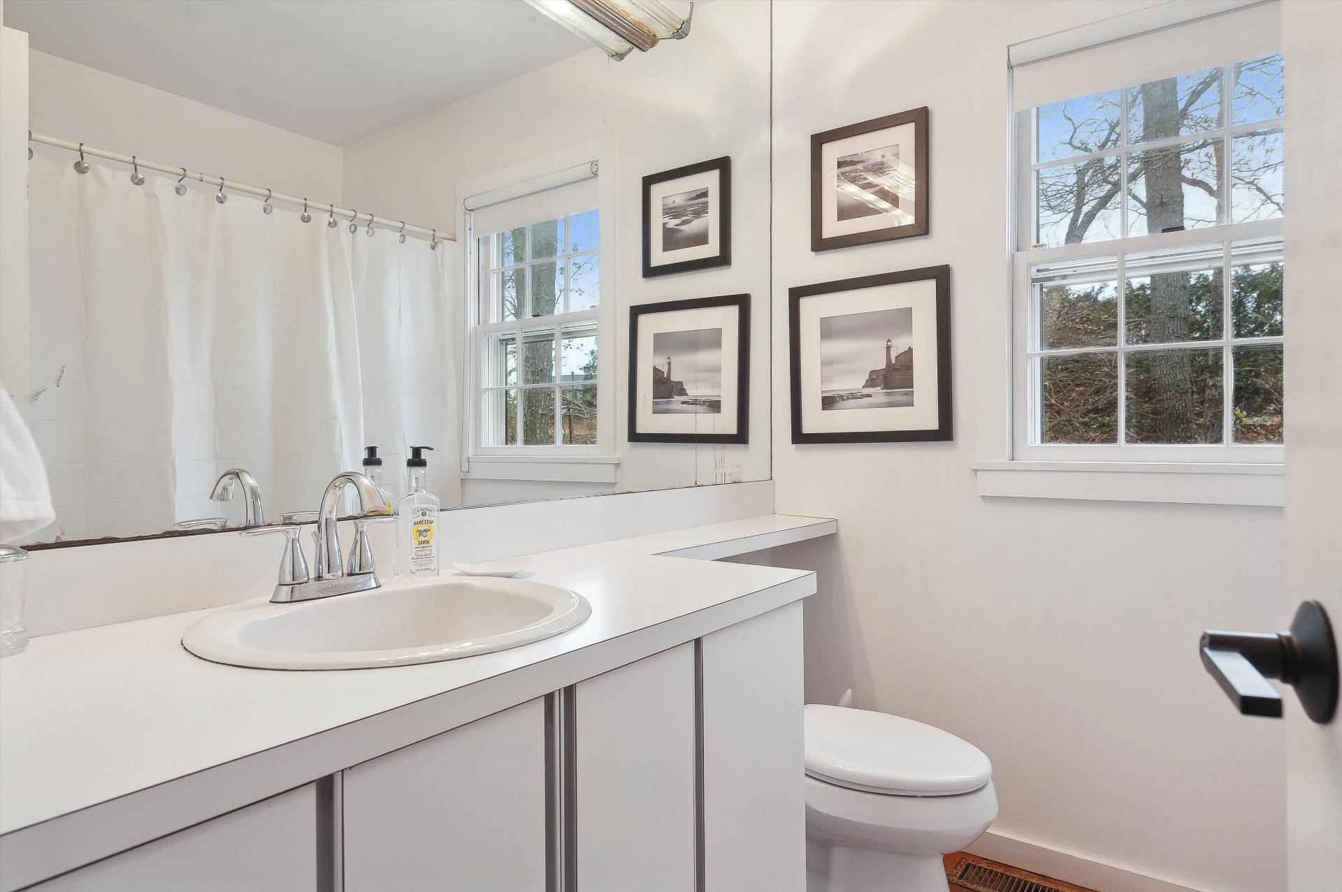 356 7 Ponds Towd Road Water Mill, NY 11976 - Photo 16 of 22 a bathroom with a sink toilet and a mirror