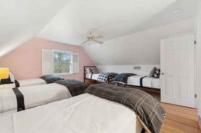 a bedroom with two beds and a large window