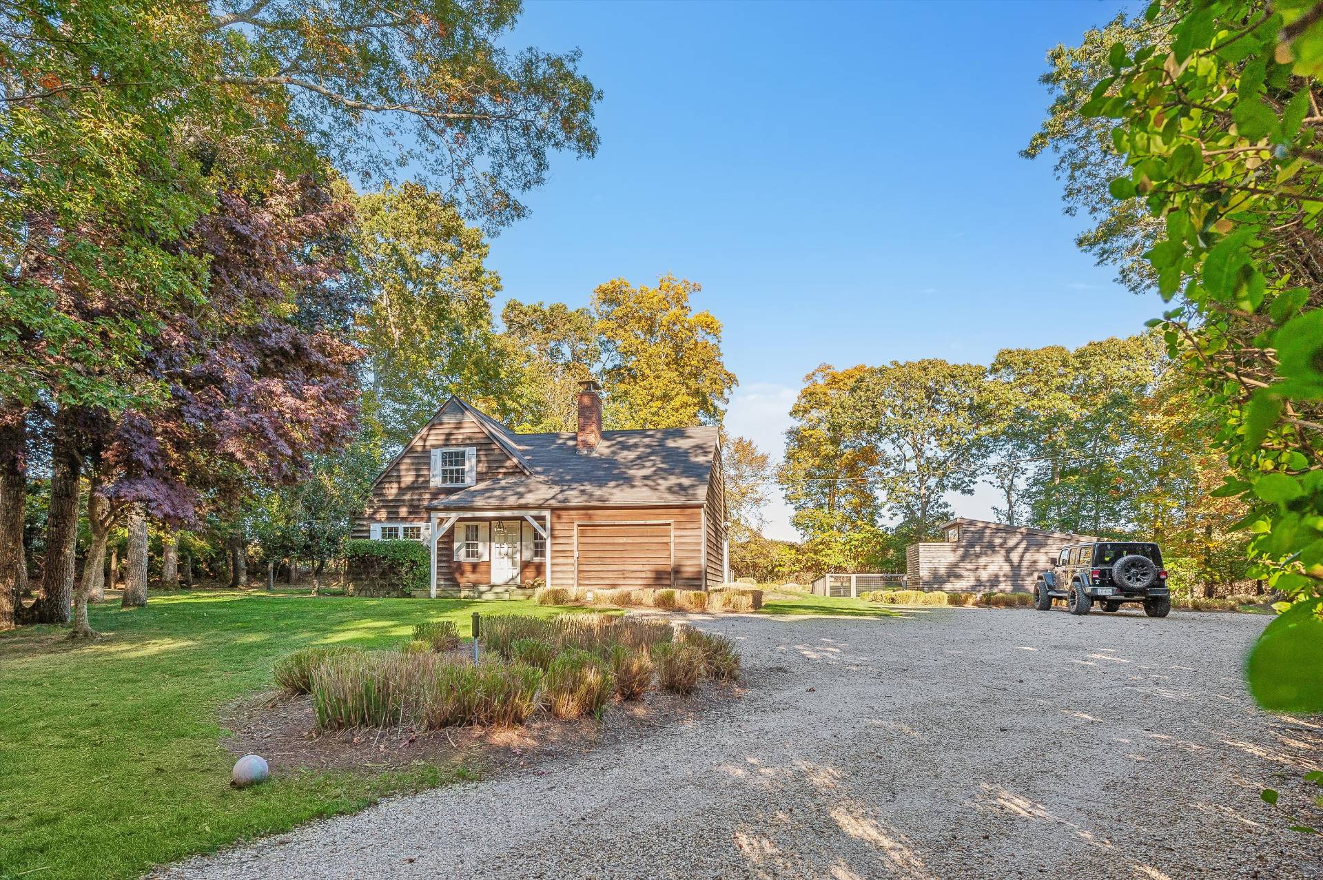 356 7 Ponds Towd Road Water Mill, NY 11976 - Photo 2 of 22 a front view of a house with a yard and garage