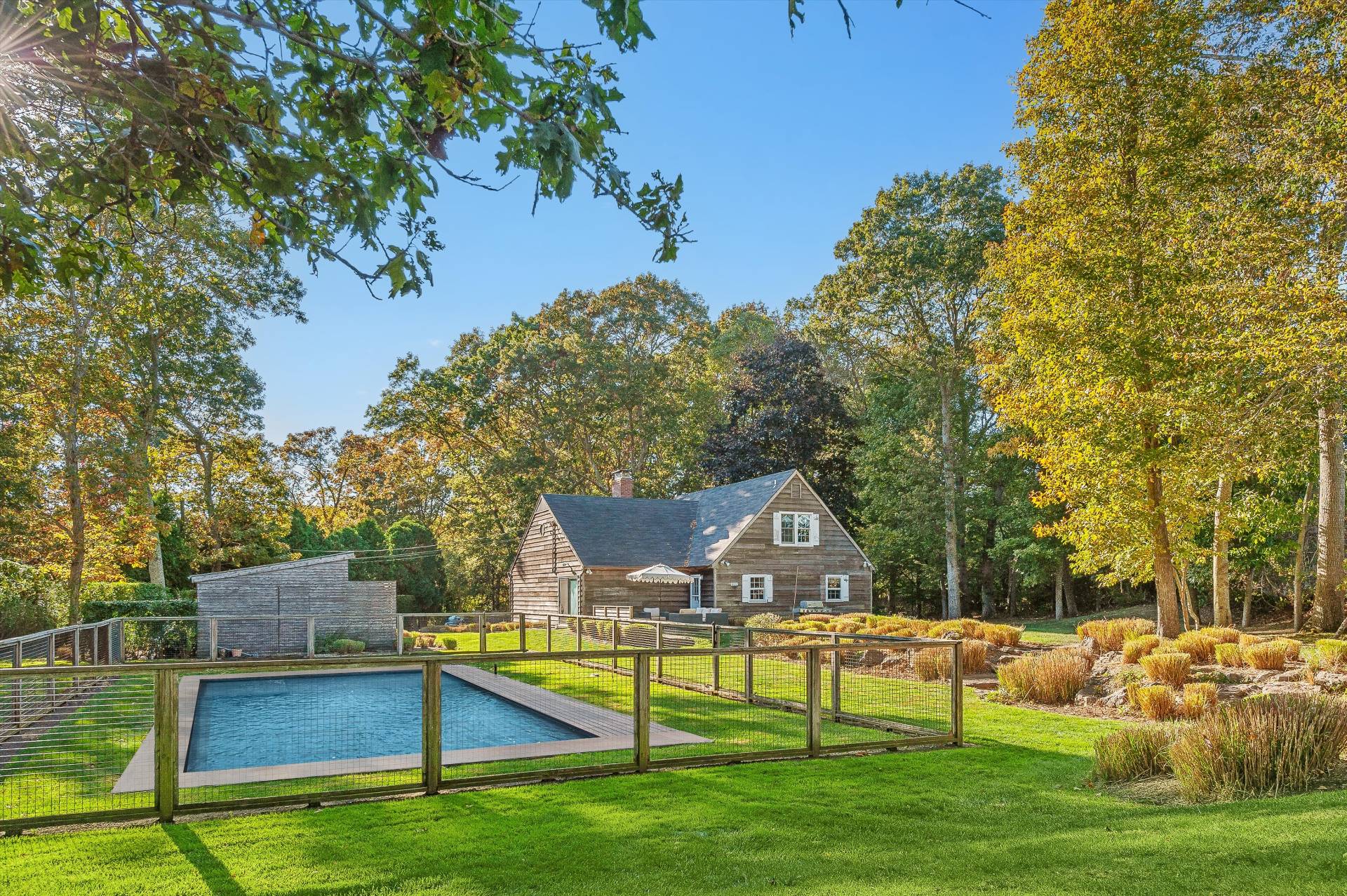 356 7 Ponds Towd Road Water Mill, NY 11976 - Photo 6 of 22 a front view of a house with garden